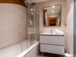 A modern bathroom with a glass-enclosed shower, a white sink, and a mirror above it. - Spacious chalet, panoramic view - 8 guests (Les Deux Alpes)