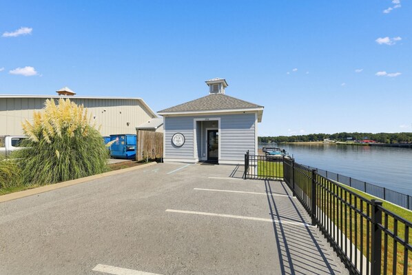 A waterfront property with a small building, a parking area, and a river. - Lake Access & Boat Slip: Greenwood Cottage! (Greenwood)