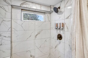 A bathroom with a shower, a window, and a towel rack. - New Private 2bd 1 ba, Hot tub, Trails, Waterfront! (Friendsville)