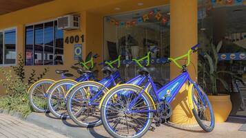 A row of bicycles parked outside a building with a yellow facade and the number 4001.