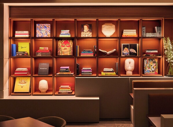 A bookshelf with various books and decorative items.