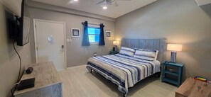 A bedroom with a bed, bedside lamps, a desk, and a television. - Hidden Gem One of Port A’s best-kept secrets (Port Aransas)