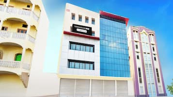 A multi-story building with a sign indicating it is a company-serviced townhouse.