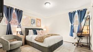A bedroom with a bed, a chair, a desk, and curtains. - Big City Retreat with Parking (North Bergen)