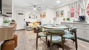 A modern kitchen with a dining area, a ceiling fan, and a coffee machine. - Big City Retreat with Parking (North Bergen)
