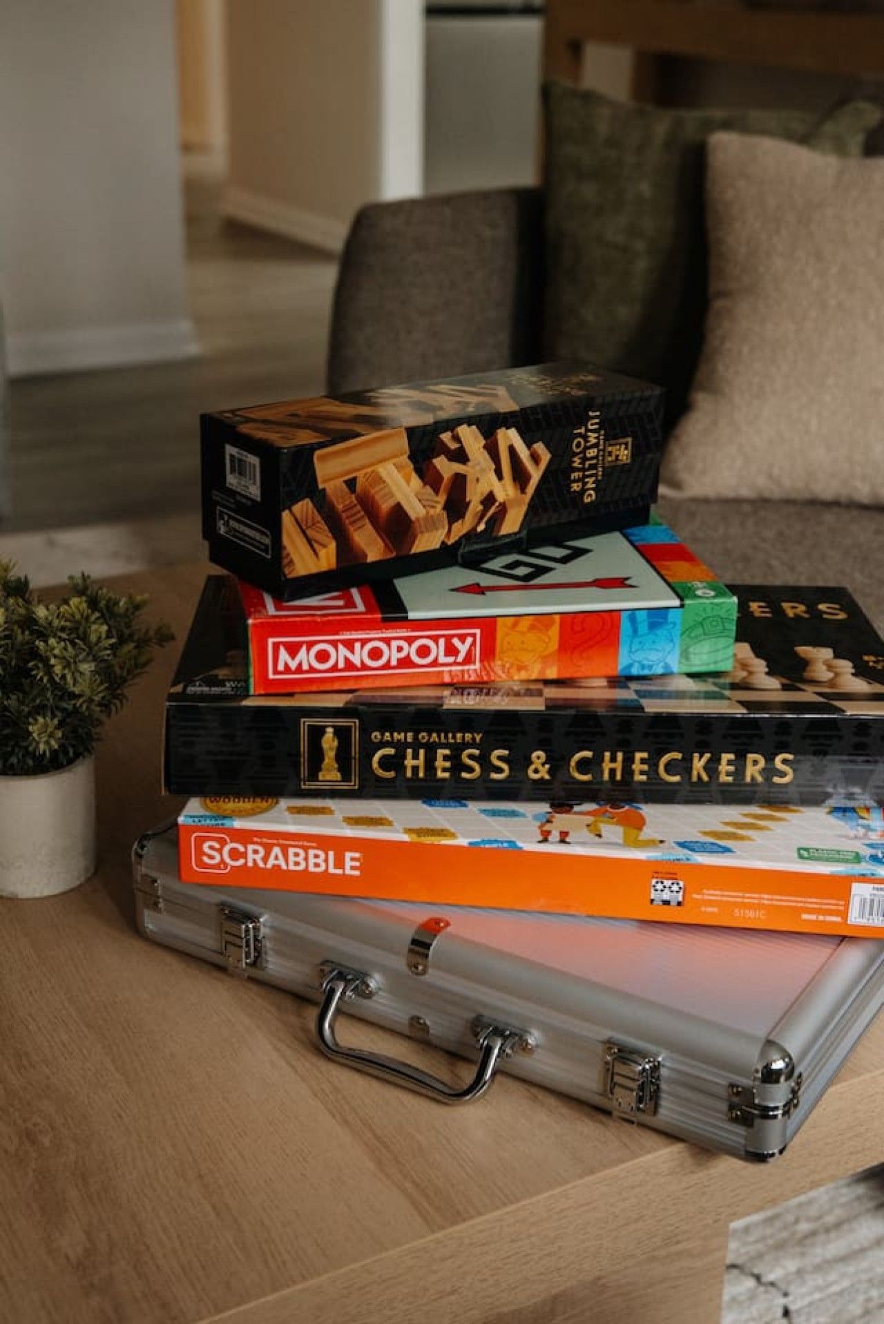 A stack of board games on a suitcase.