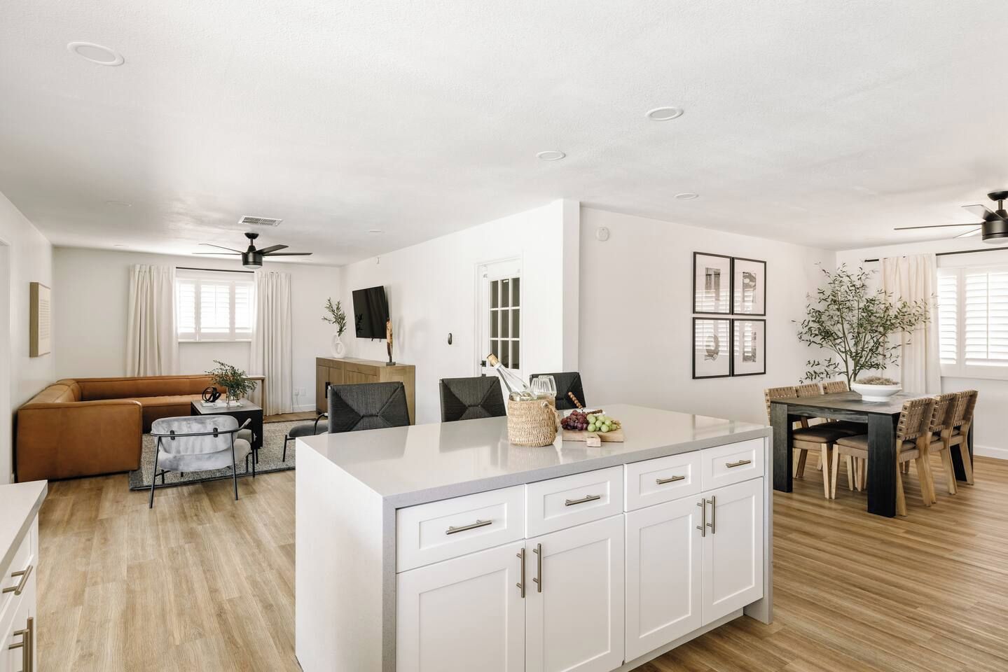 A modern living space with a kitchen, dining area, and seating area.