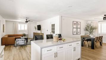 A modern living space with a kitchen, dining area, and seating area.