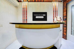 A reception desk with a sign that reads 'TOWN HOUSE OAK Company-Serviced.'