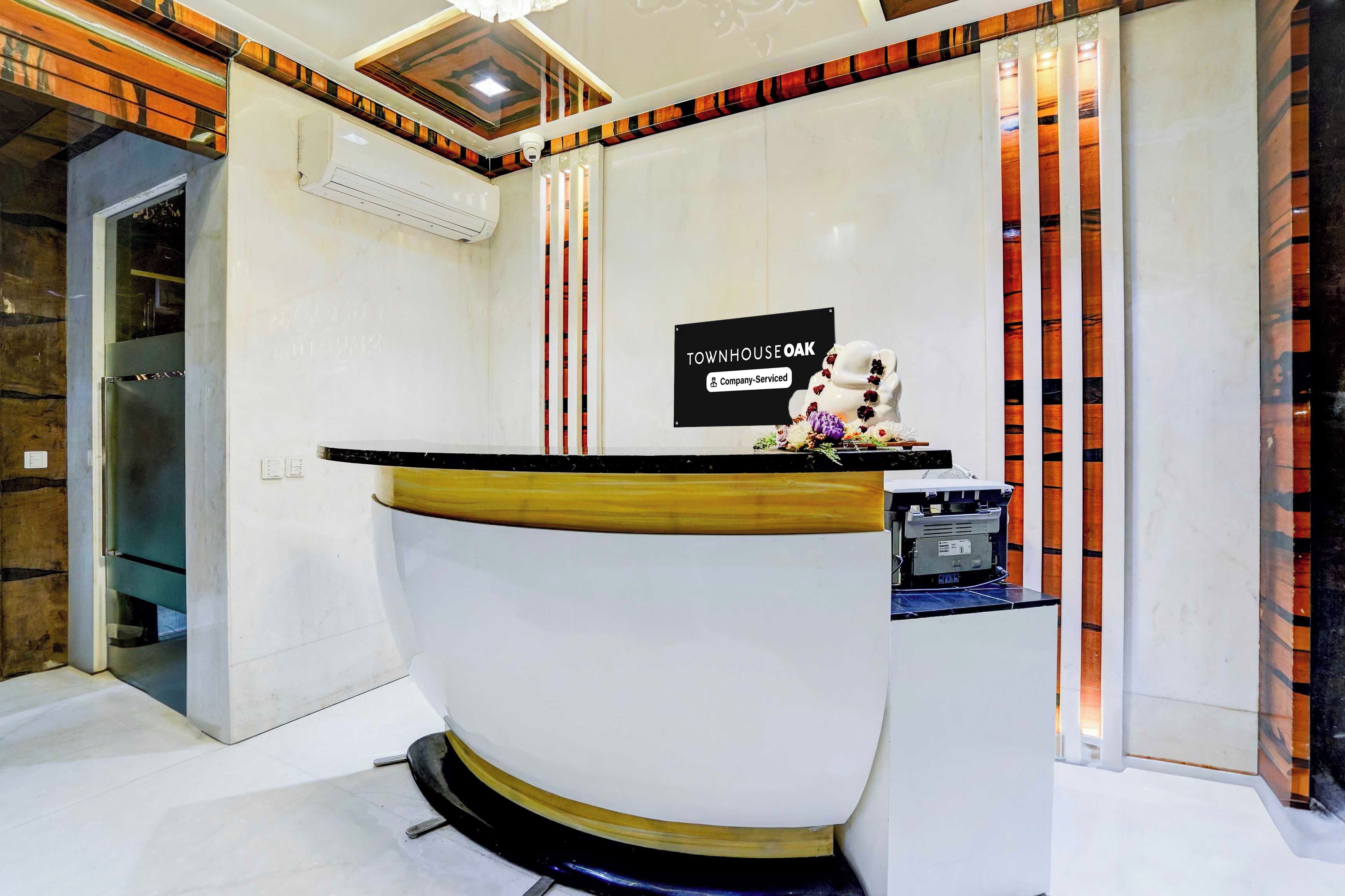 A reception desk with a sign indicating it is company-serviced.