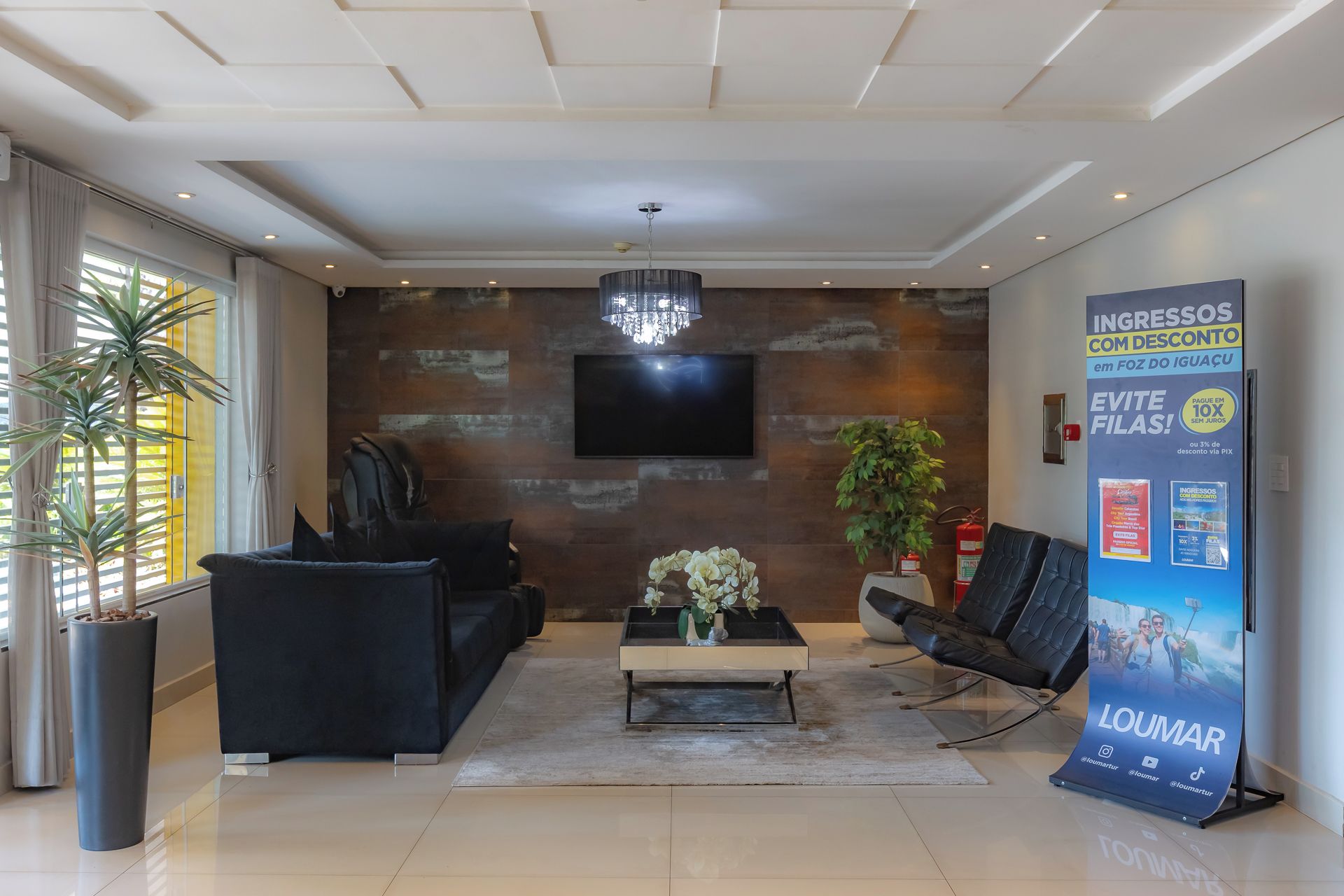 A modern lobby with a sofa, coffee table, and a large poster.