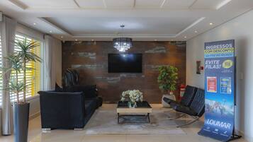 A modern lobby with a sofa, coffee table, and a large poster.