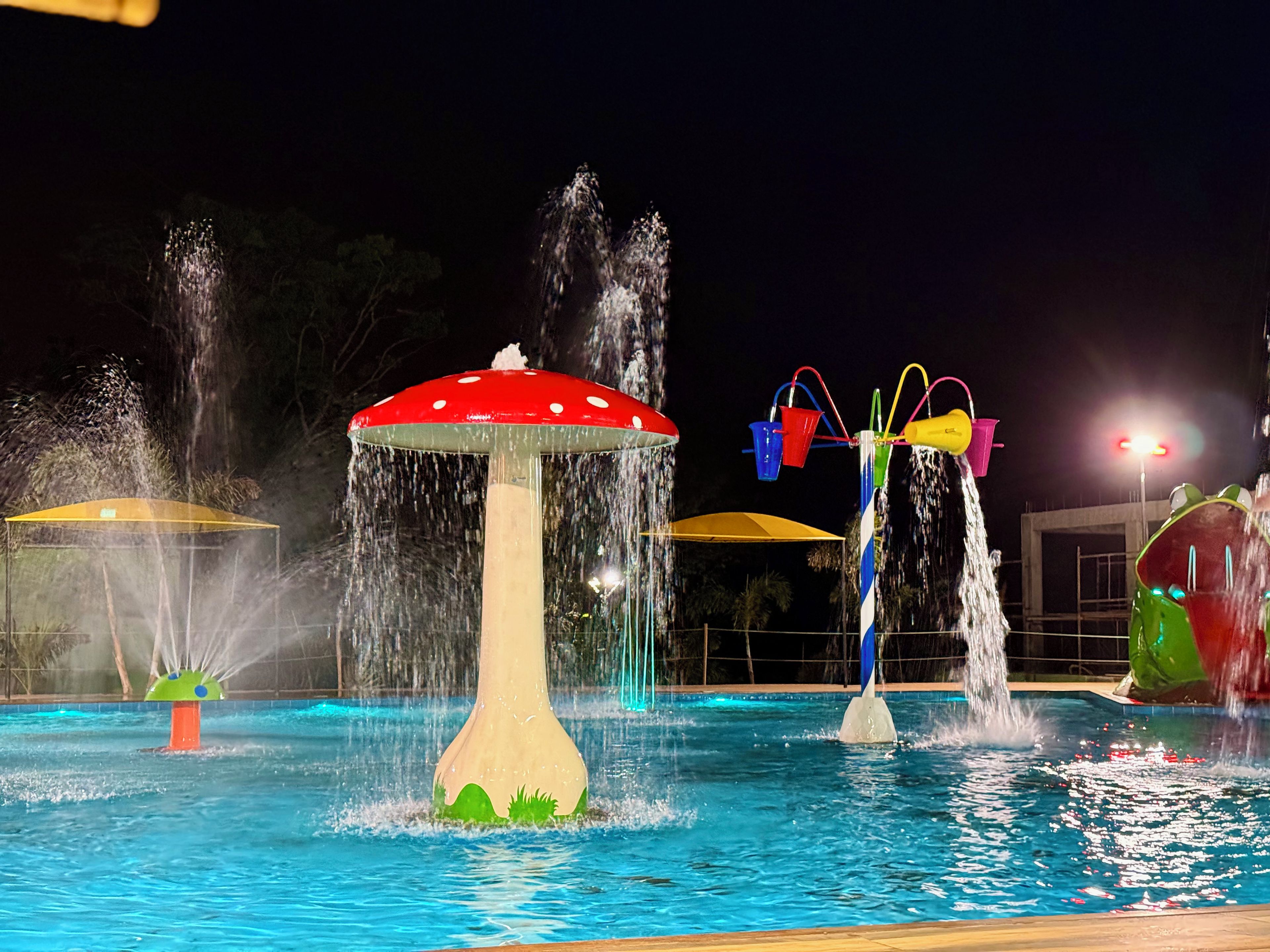 A water feature with a mushroom-shaped fountain and multiple water jets.