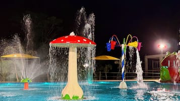 A water feature with a mushroom-shaped fountain and multiple water jets.