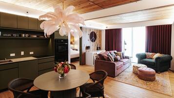 A modern living space with a kitchen, dining area, and seating area.