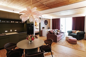 A modern living space with a kitchen, dining area, and seating area. - bohème (Austin)