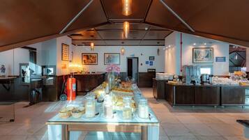 A breakfast buffet setup with various food items and a coffee station.