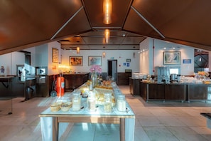 A breakfast buffet setup with various food items and a coffee station. - Costa Verde By Candeias (Bombinhas)