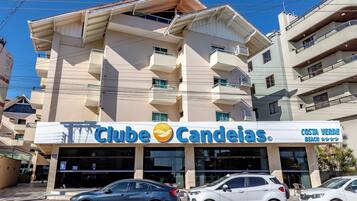 A building with a sign for 'Clube Candeias' and 'Costa Verde Beach' indicating a hotel or resort.