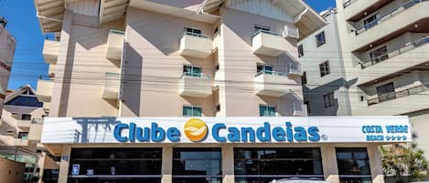 A building with a sign for 'Clube Candeias' and 'Costa Verde Beach' indicating a hotel or resort.