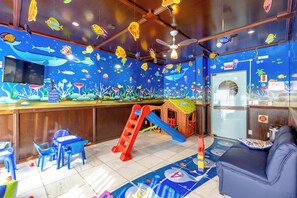 A children's play area with a slide, playhouse, and seating. - Costa Verde By Candeias (Bombinhas)