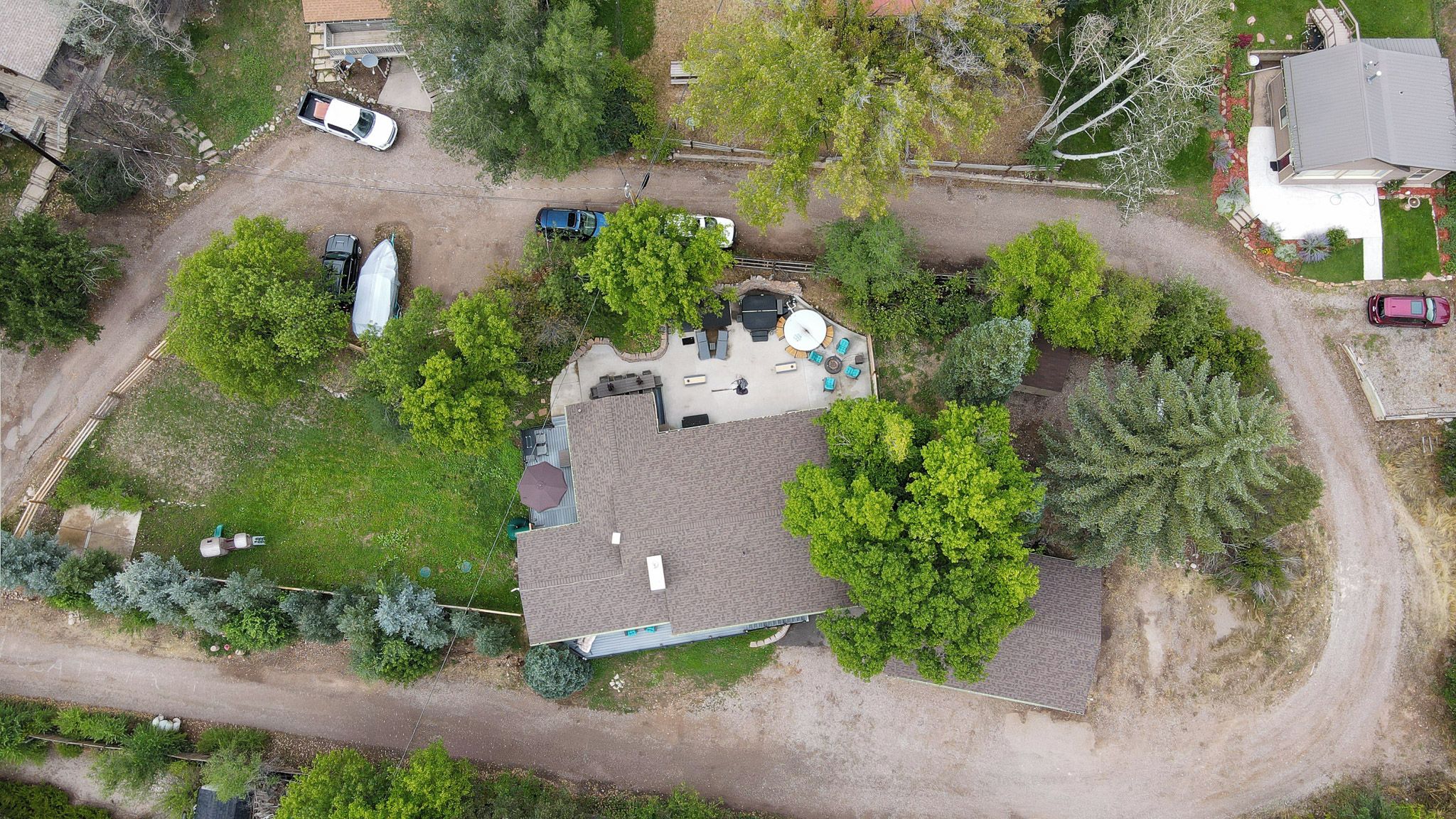 A residential property with a detached house, a fenced yard, and a driveway.