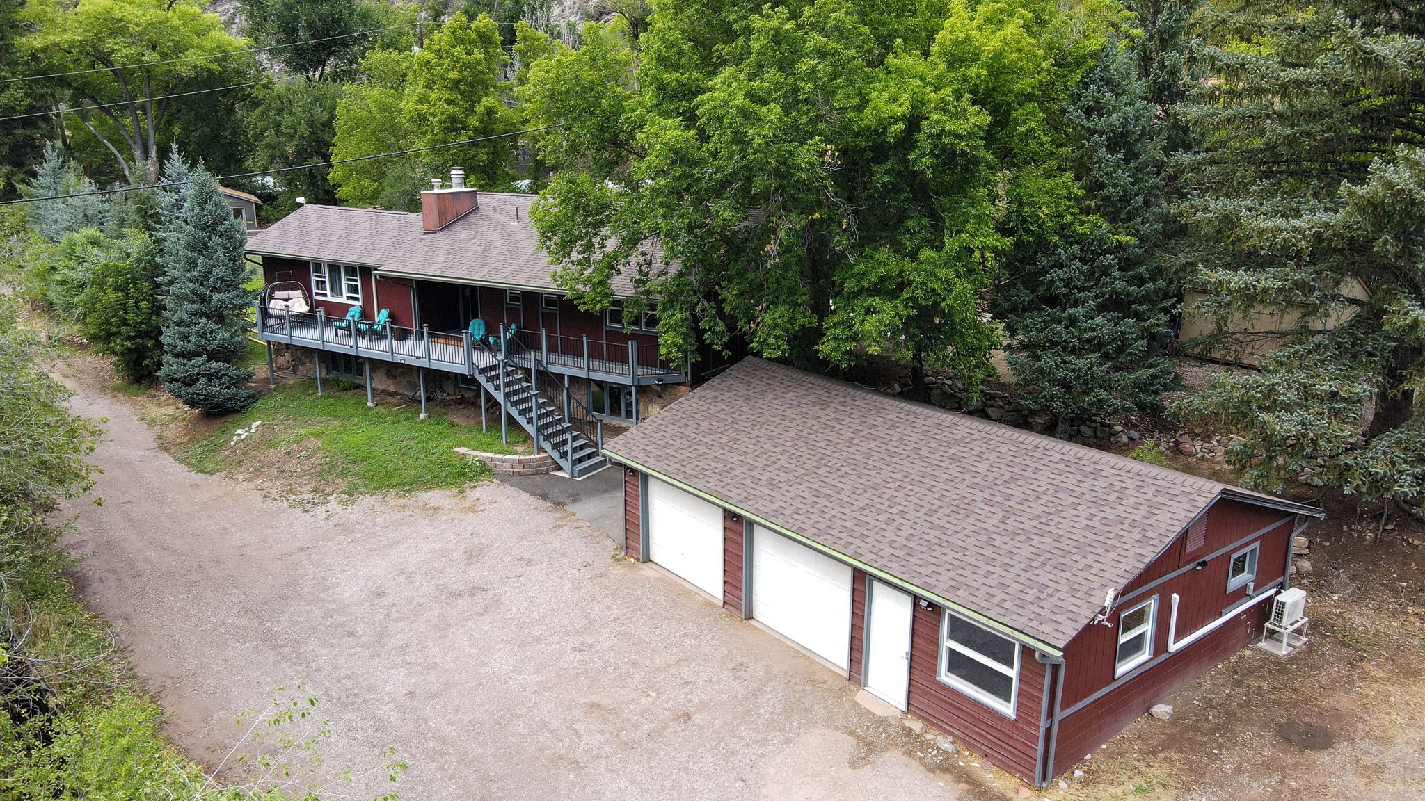 A two-story house with a covered porch and a garage.