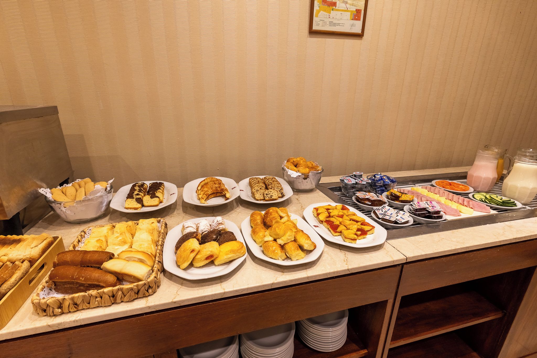 A buffet table with various food items and beverages.