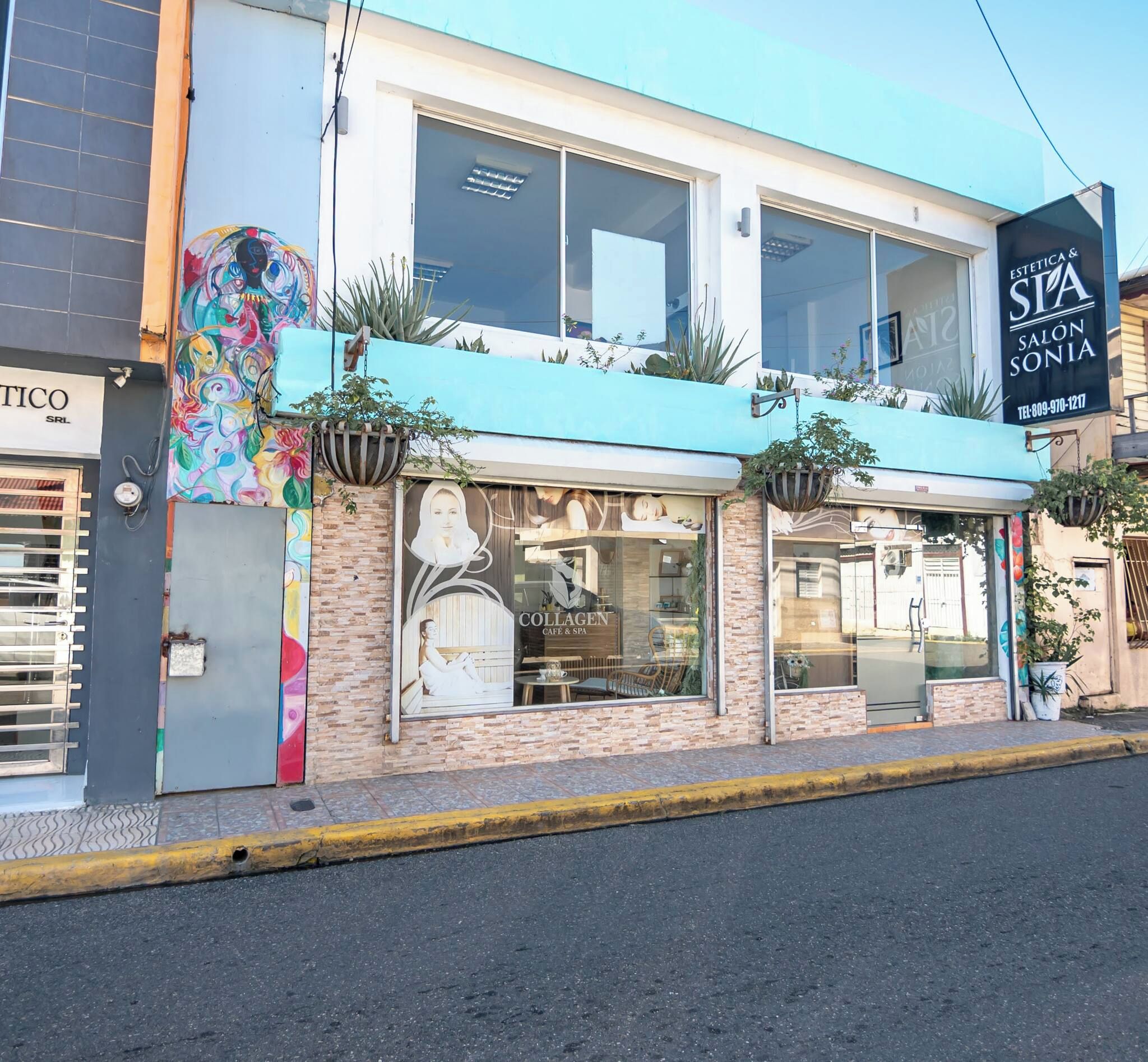 A building with a spa salon, Collagen Cafe & Bar, and a colorful mural.