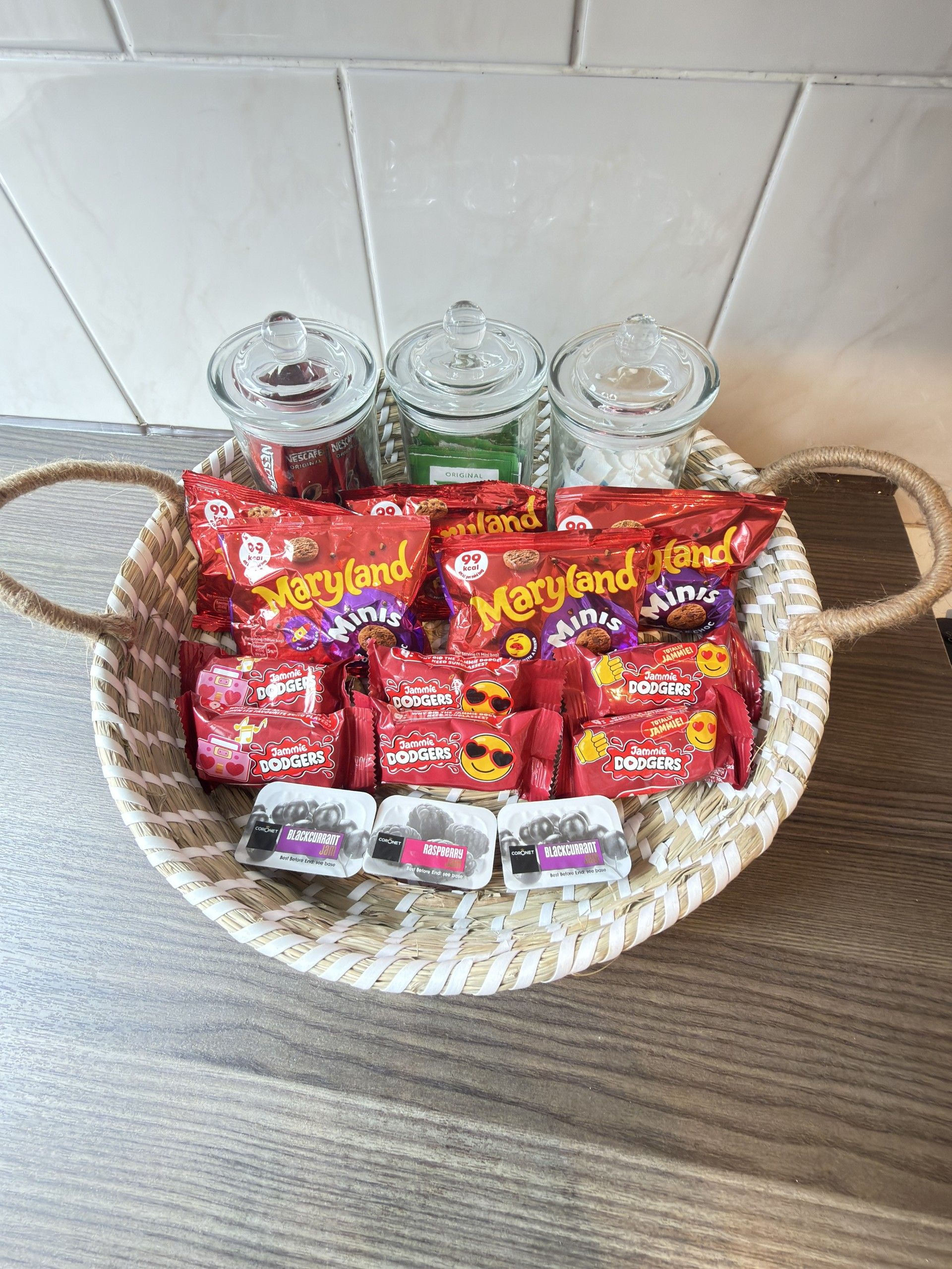 A basket containing various snack items including chips, cookies, and chocolate bars.