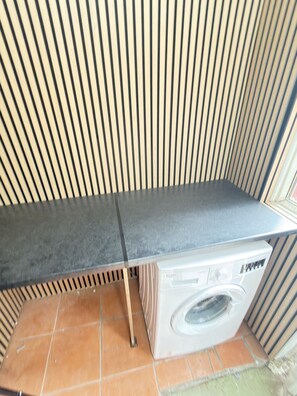 A laundry area with a washing machine, a drying rack, and a tiled floor. - Contractors, Holiday home, entire house in Merseyside, United Kingdom Holiday, (Liverpool)