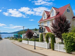 En tvåvåningsbyggnad med ett rött tak och en skylt som visar att det är Crofton Seaside Inn.