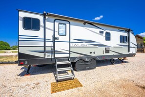 A recreational vehicle with a ramp and a welcome mat. - Glamping Getaway - On the 290 Wine Trail (Fredericksburg)