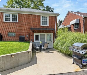 A brick house with a patio, outdoor grill, and a small garden. - Fabulous 3-bedroom 2 bath house with Central AC - 2 complete living spaces!  (Mansfield)