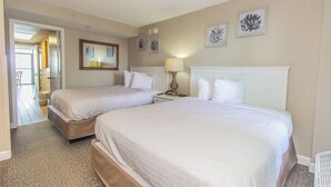 A hotel room with two beds, a mirror, and artwork on the wall. - Cozy Oceanfront Getaway! Landmark 640 for 6! (Myrtle Beach)