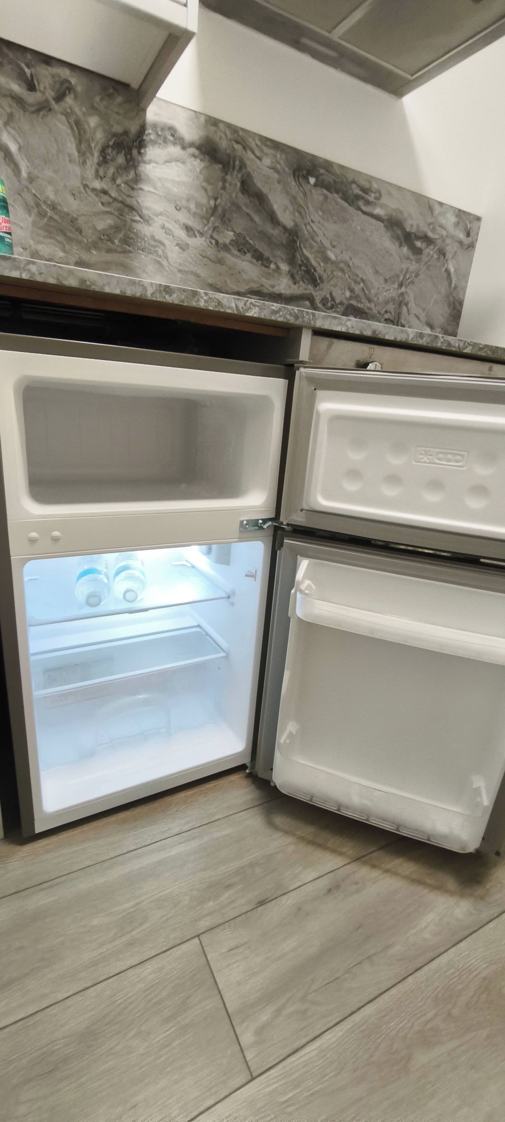 A kitchen with a built-in refrigerator and a microwave.