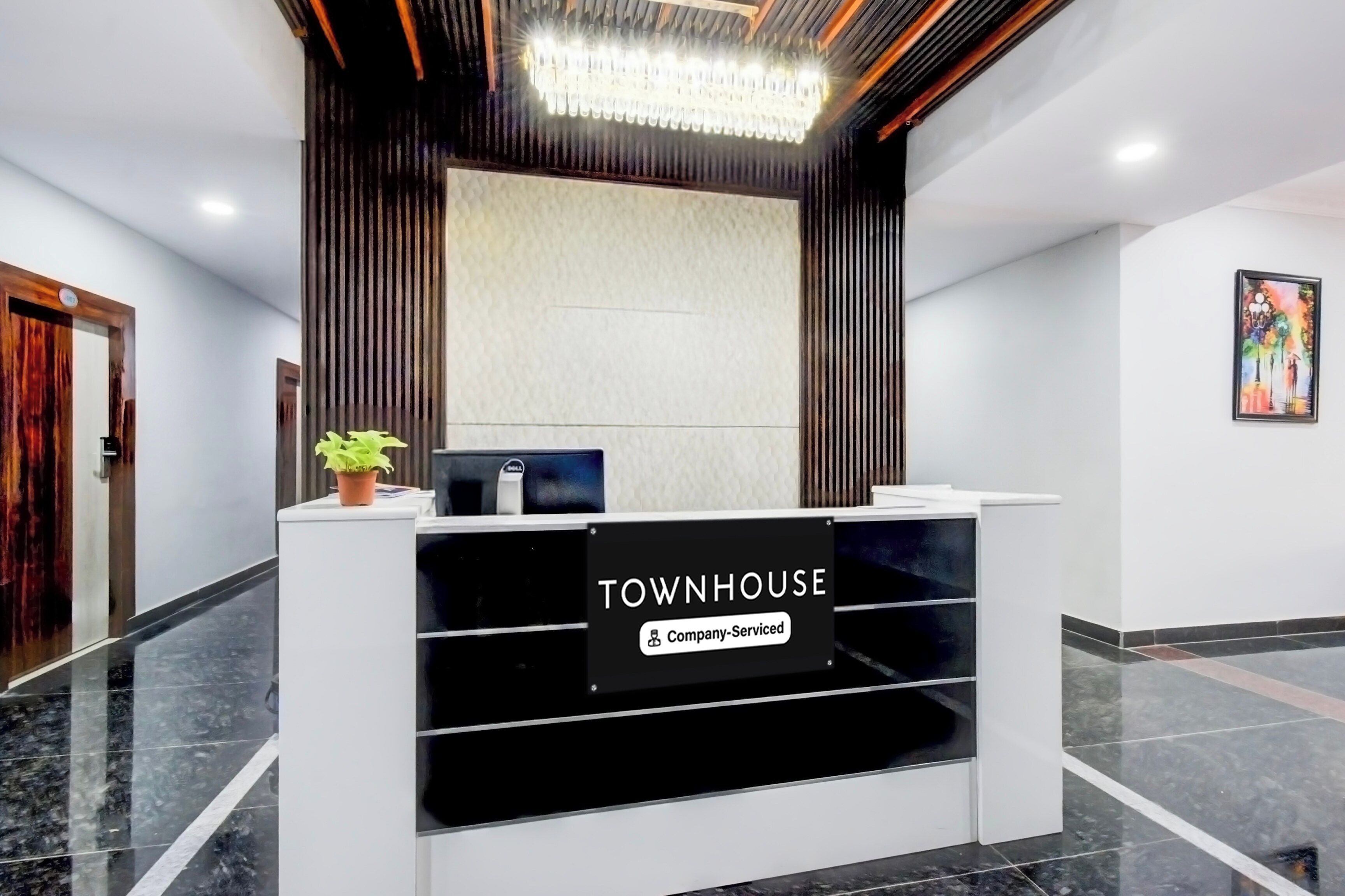 A reception desk with a sign reading 'TOWNHOUSE Company-Serviced.'