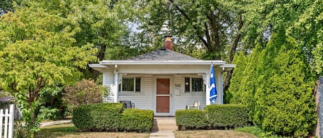 A single-story house with a front porch, a chimney, and a mailbox.
