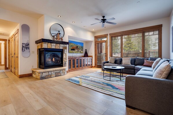 Sink into plush seating and warm up by your own stone fireplace in this mountain-inspired living room, where natural light and cozy textures create your perfect retreat. - EL5109 | Private Hot Tub | Winter Shuttle | Air Chilling | Pool (Steamboat Springs)
