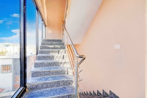 A staircase with metal railings leading to an upper floor.
