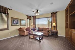 A living room with a ceiling fan, two sofas, a coffee table, and a side table with lamps. - Game loft retreat & patio near the Strip 5BR (Las Vegas)