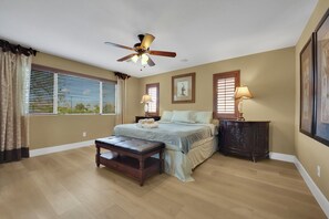 A bedroom with a bed, a nightstand, a lamp, a ceiling fan, and a window with blinds. - Game loft retreat & patio near the Strip 5BR (Las Vegas)