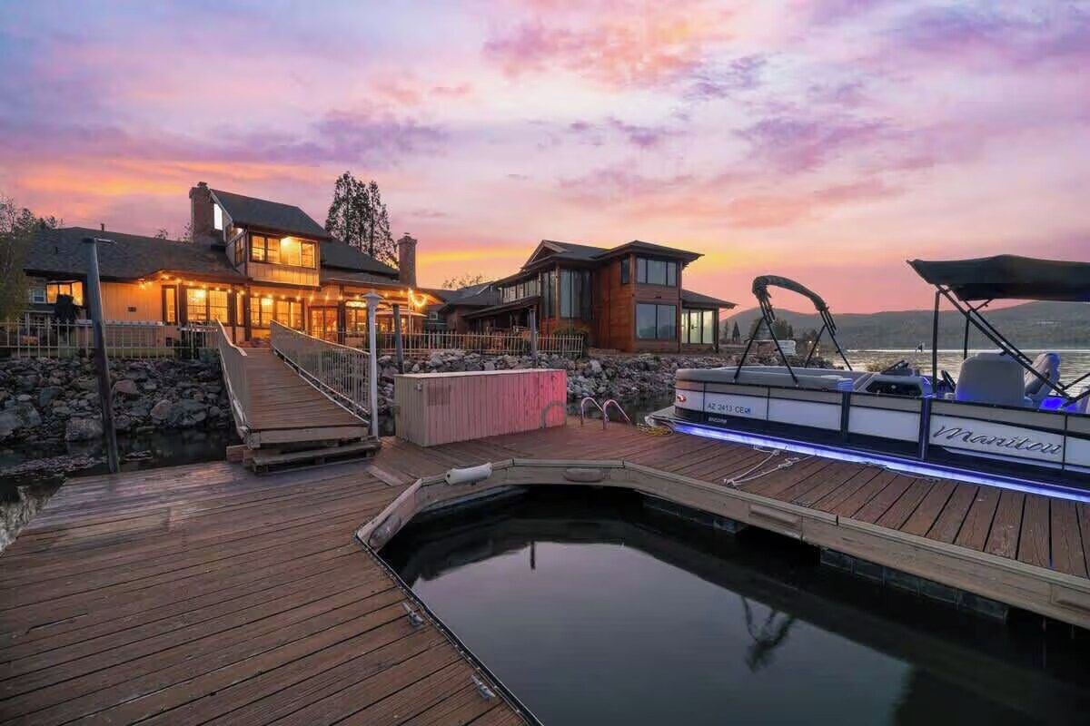 A waterfront property with a dock, a swimming pool, and a boat named 'Marriott.'
