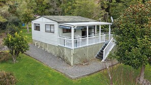 A single-story house with a porch and a small deck.