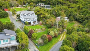 A large two-story house with a spacious front yard and a driveway leading to a garage. - The Bay House - Moetapu Holiday Home (Picton)