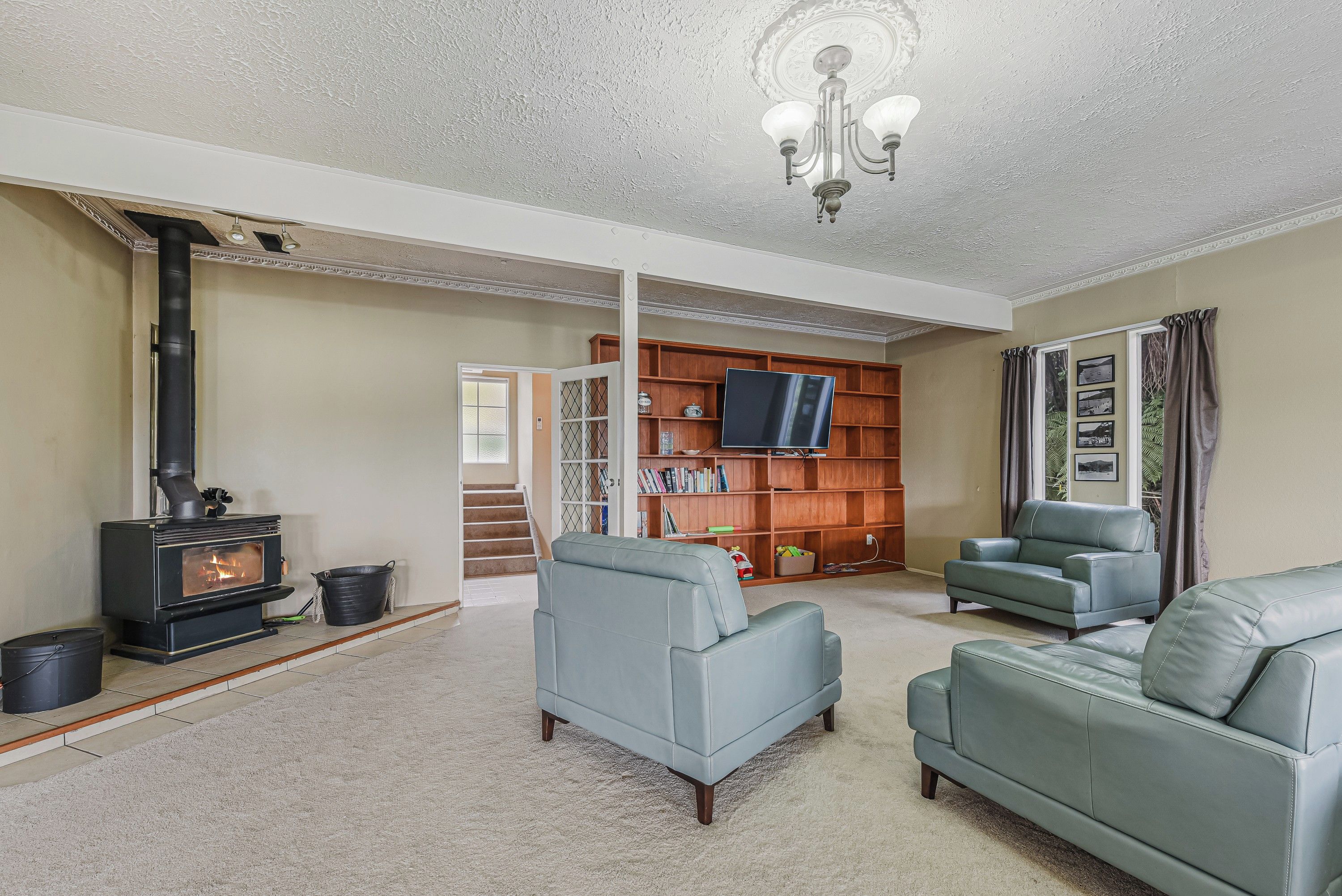 A living room with a fireplace, a television, and seating.