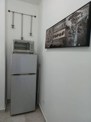A kitchenette with a built-in microwave and refrigerator. - Lovely 2 Bedrooms Apartment With Terrace, Small Pool Share (San Juan)