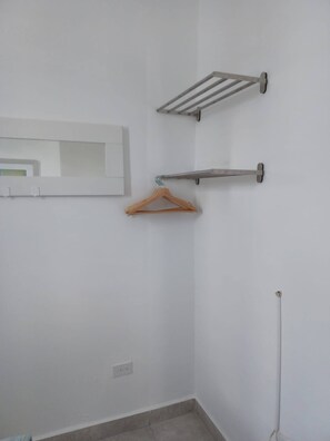 A corner of a room with a white wall, a towel rack, and a wooden hanger. - Lovely 2 Bedrooms Apartment With Terrace, Small Pool Share (San Juan)