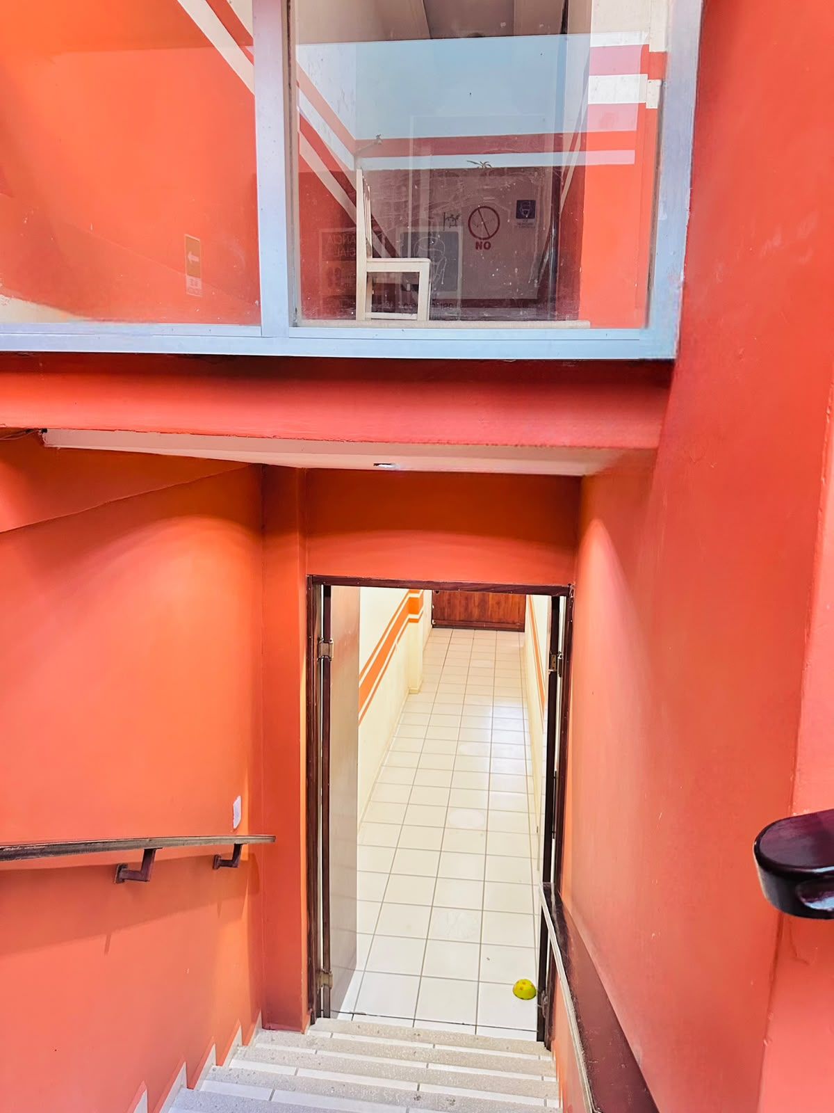 A multi-level building with a staircase leading to a corridor.