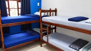 Habitación con literas, una ventana y cortinas.